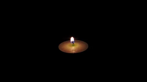 Warm Flickering Tealight Candle Flame in a Pitch Black Room, 4K Stock Footage 336032562
