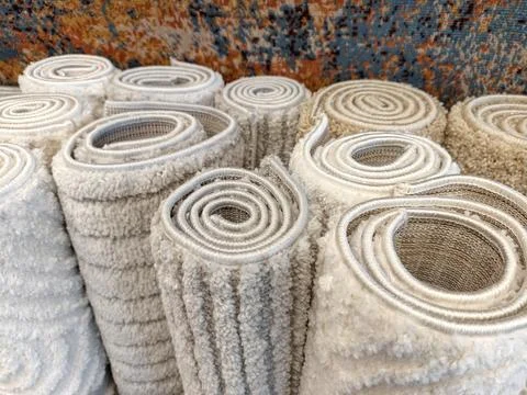 Warm fluffy carpets in light and gray tones displayed in a mall showcasing .. Stock Photos