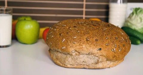 Warm fresh bread with Seeds on the table in kitchen Stock Footage 129092117