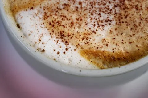 Warm frothy coffee surface experience. Warm brown coffee foam with delicate bubb Stock Photos
