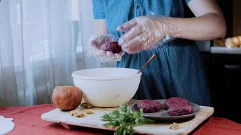 Warm garnished dish view: pressing walnut garnish into each portion Stock Photos
