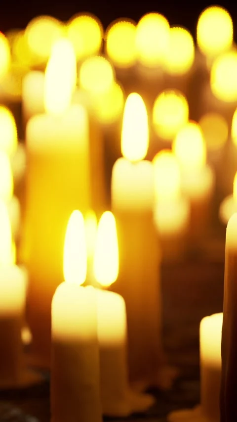 Warm glow of candles in a dimly lit space during a gathering Video stock 340631295