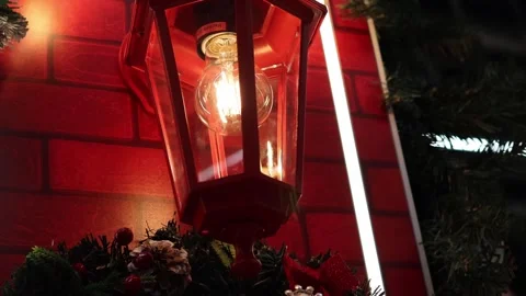 Warm glow of a festive lantern against a cozy brick backdrop Vídeos de archivo 296145223
