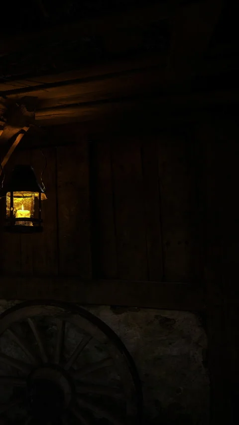 Warm glow of a lantern illuminating a rustic barn at night Stock Footage 331810388