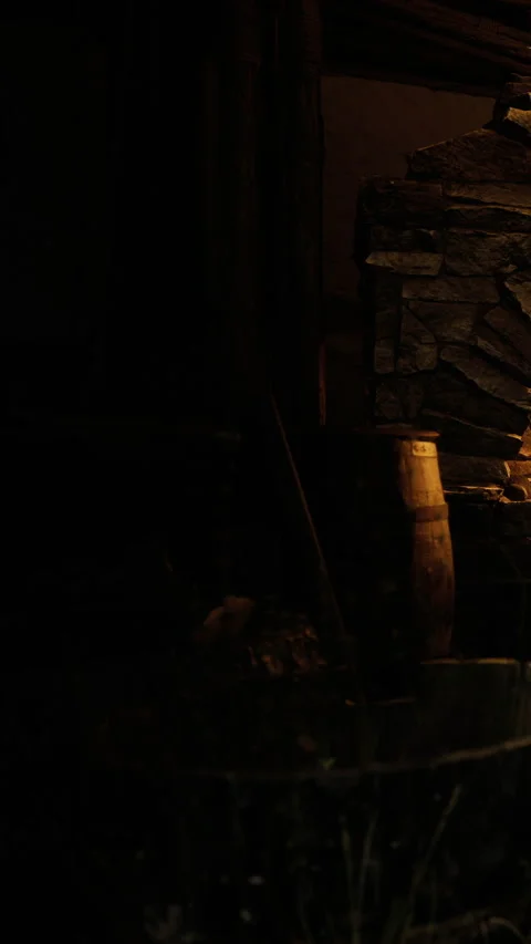 Warm glow of light dancing on stone walls in cozy cabin setting Stock Footage 331830344