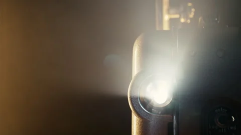 Warm glow of projector beam light. Nostalgic charm of classic cinema. Retro Stock Footage 263561594