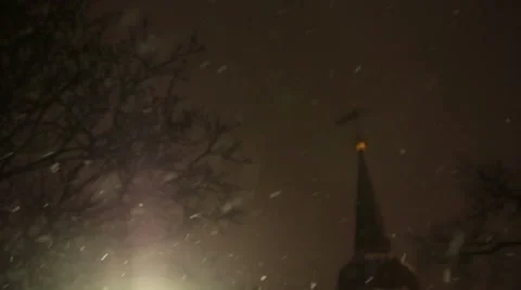 Warm Glow of Street Light Surrounded by Snowflakes in First Snowfall of the Video stock 58936805