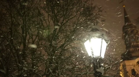 Warm Glow of Street Light Surrounded by Snowflakes in First Snowfall of the Video stock 58936811