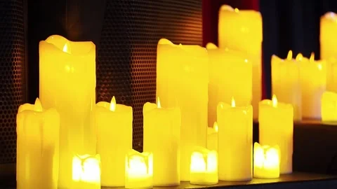 Warm glow of yellow candles creating a serene atmosphere Stock Footage 319020137