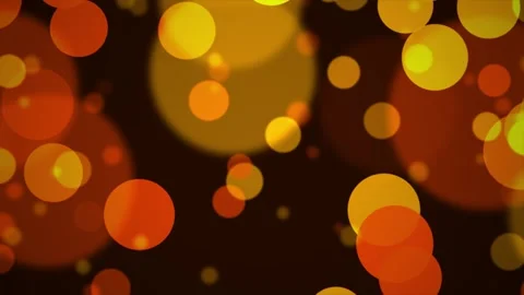 Warm glowing bokeh circles gently floating in a dark ambient background dur.. Video stock 344289128