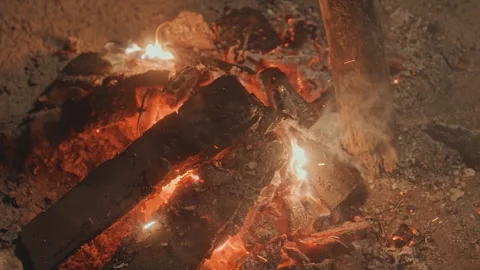 Warm glowing coals. Nighttime campfire with sparks. Candles flickering over Stock Footage 338010515