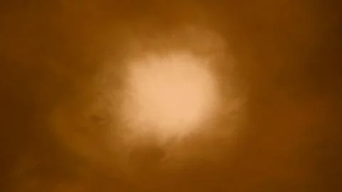 Warm golden light gently illuminates a cloudy sky, perfect for backgrounds or Illustrazione stock