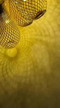 Warm golden string lights with a beautiful metallic mesh texture creating a.. Stock Photos