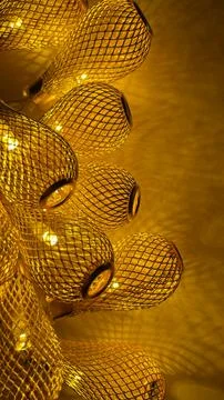 Warm golden string lights with a beautiful metallic mesh texture creating a.. Stock Photos