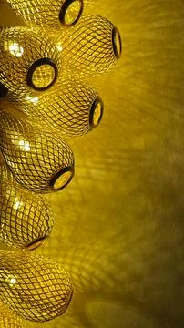 Warm golden string lights with a beautiful metallic mesh texture creating a.. Stock Photos
