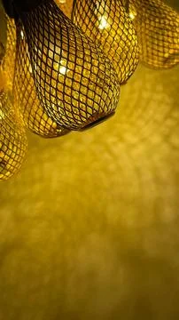 Warm golden string lights with a beautiful metallic mesh texture creating a.. Stock Photos