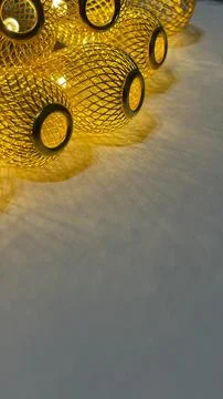 Warm golden string lights with a beautiful metallic mesh texture creating a.. Stock Photos