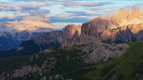 Warm golden sunlight bathing rugged Cinque Torri rock formation, Stock Footage 314960089