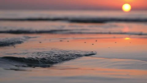 Warm golden sunset glows peacefully over calm ocean beach shore. Stock Footage 337413999