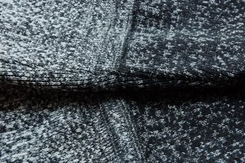Warm gray light dark gradient woolen sweater sleeve wool close-up. Stock Photos