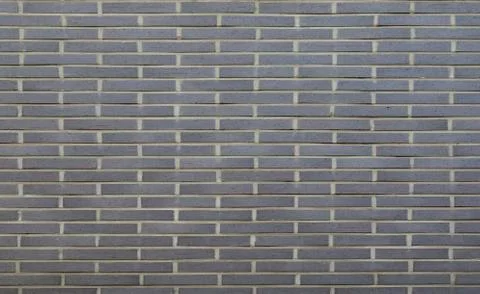 Warm grey brick wall texture background. Tiled Stock Photos