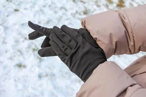 Warm hands in black gloves preparing for winter activities outdoors Stock Photos