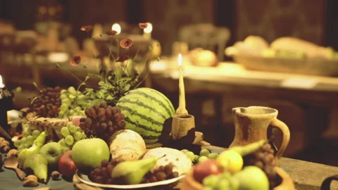 Warm Harvest Table Setting with Fresh Fruits and Soft Lighting Stockbeeldmateriaal 339799624