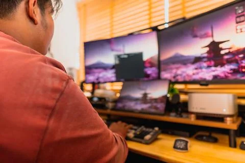 Warm home workspace with blurred computer monitors. Stock Photos