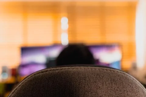 Warm home workspace with blurred computer monitors. Stock Photos