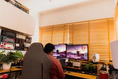 Warm home workspace with blurred computer monitors. Stock Photos