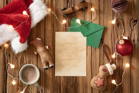 A warm, inviting setup features a mug of cocoa surrounded by holiday decorati Stock Photos