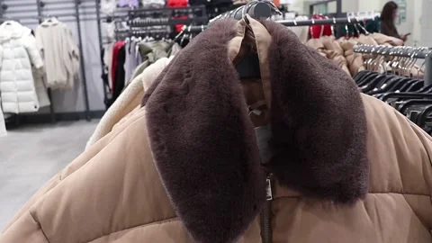 Warm jacket with fur collar in the store Stock Footage 260439895