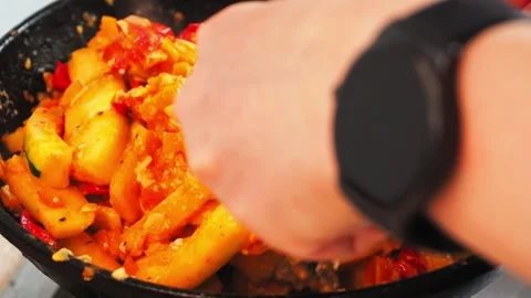 In a warm kitchen, pumpkin and vegetables are being saut ed for a delicious stew Stock-Footage 316661660
