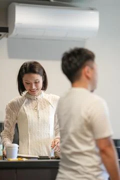 Warm kitchen scene, gentle interaction Stock Photos