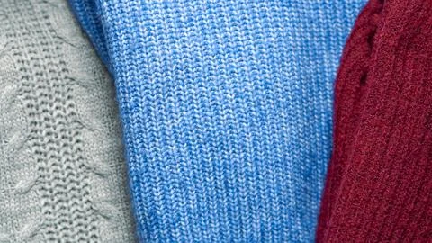 Warm knitted sweaters concept representing cozy winter wardrobe and cold seas Stock Photos