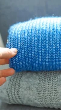 Warm knitted sweaters concept representing cozy winter wardrobe and cold seas Stock Photos