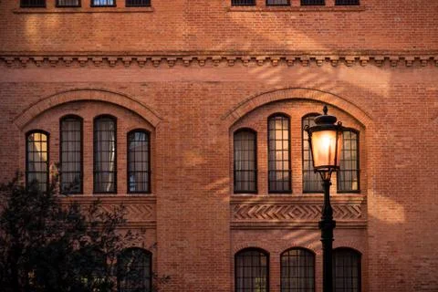 Warm lantern in front of brick facede with old windows in Venice 写真素材