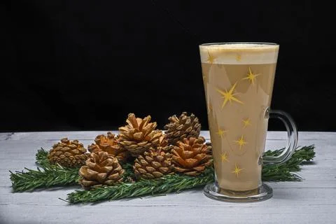Warm latte with star-patterned foam sits on rustic table Stock Photos