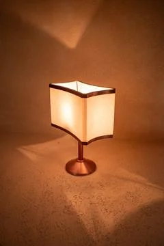 Warm light casts soft shadows from a square lamp Stock Photos