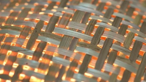 Warm Light Glowing Through Woven Bamboo Texture – Close Up Abstract Vídeos de archivo 333692358