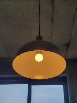 Warm light hangs from concrete ceiling Stock Photos