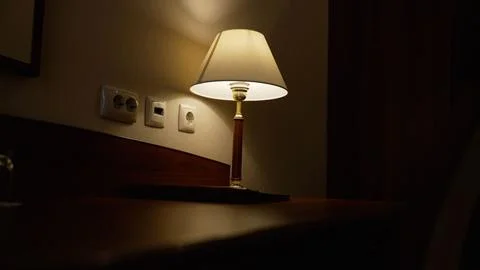 Warm Light Illuminating Table Lamp and Wall Outlets Фото