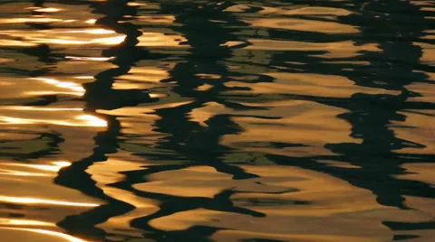 Warm Light Reflecting Off the Surface of Gentle Water Ripples. Stock Footage 50154323