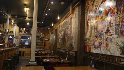 Warm lighting illuminates the inviting interior of a Spanish restaurant or bar Stock Footage 336469325