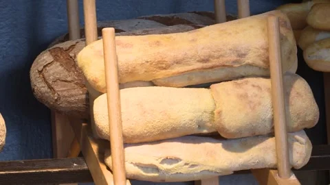 Warm Lighting over Wheat and Italian Rolls of Bread in Bakery Stock-Footage 325351899