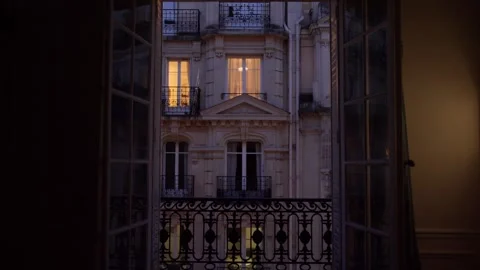 Warm lights shining through parisian apartment windows at dusk Stock Footage 307602713