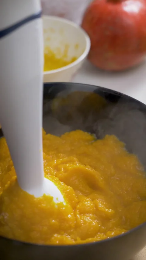 Warm mashed pumpkin mixture prepared by hand Stock Footage 345605986