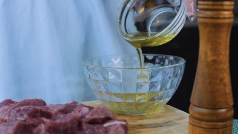 Warm meal preparation: slicing raw steak into thick strips Stock Footage 342181215