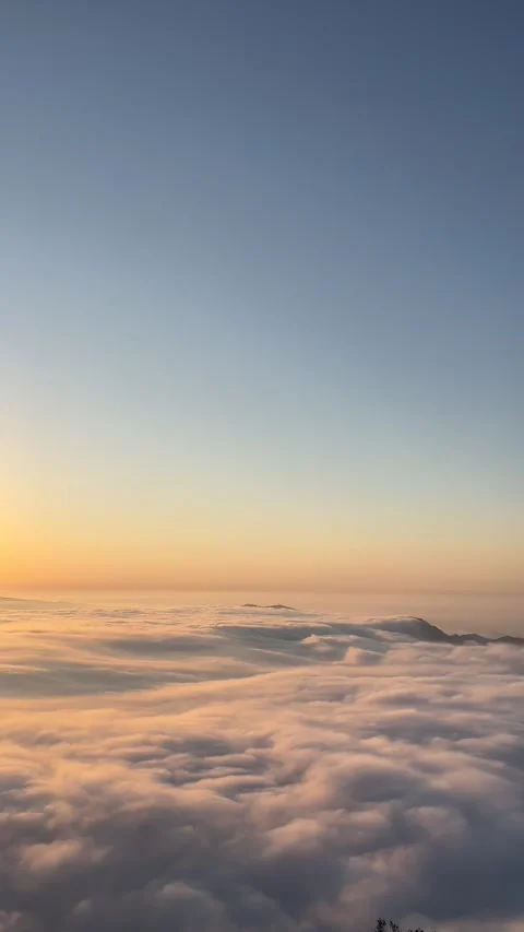 Warm morning light over a cloud inversion in the Montserrat mountains Stock Footage 344409832