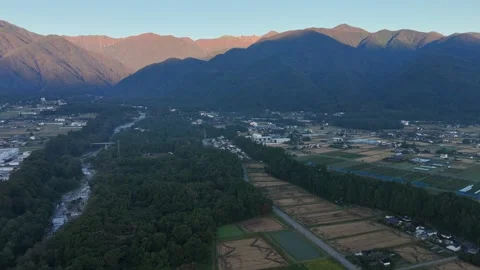 Warm Mountain Ridges Beyond Forest and Patchwork Fields Stock Footage 347492040